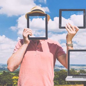 man with computers screens with clouds